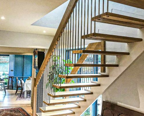 floating timber staircase with white wall stringer