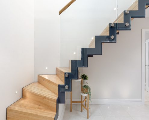 side view of zig zag steel staircase with glass balustrade