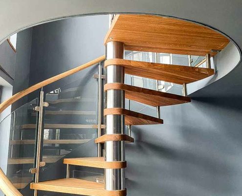 circular opening in floor with oak spiral staircase
