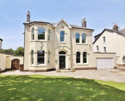 white detached house with grass to front