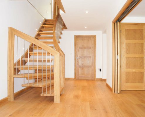 oak doors, oak floor and open oak stair with white walls