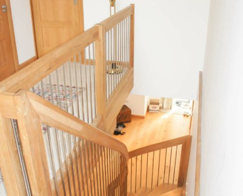 looking down an oak staircase with landing balustrade