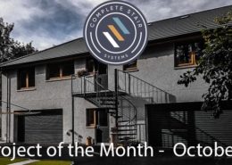 grey house with black outdoor spiral staircase