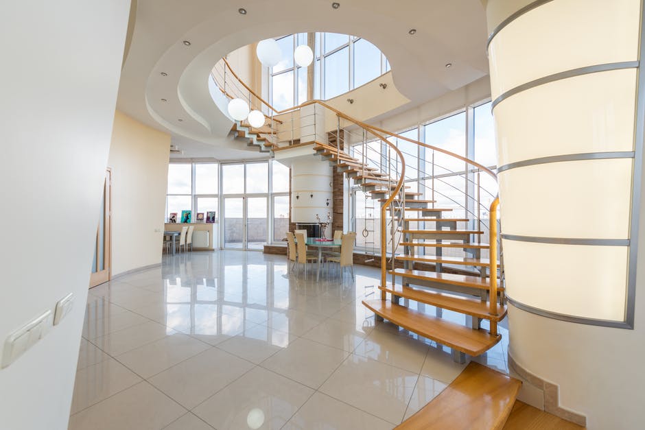 curving staircase with timber treads on a tiled floor