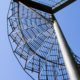 underside of grated steep spiral stair with blue sky beyond
