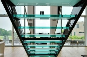 looking through the back of a glass step open riser stair to large window beyond