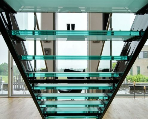 looking through the back of a glass step open riser stair to large window beyond