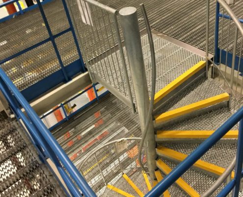 industrial spiral stair in galvanised steel with yellow nosing