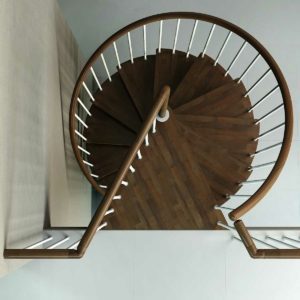 looking down on the top step of a c20 spiral stair with dark wood steps