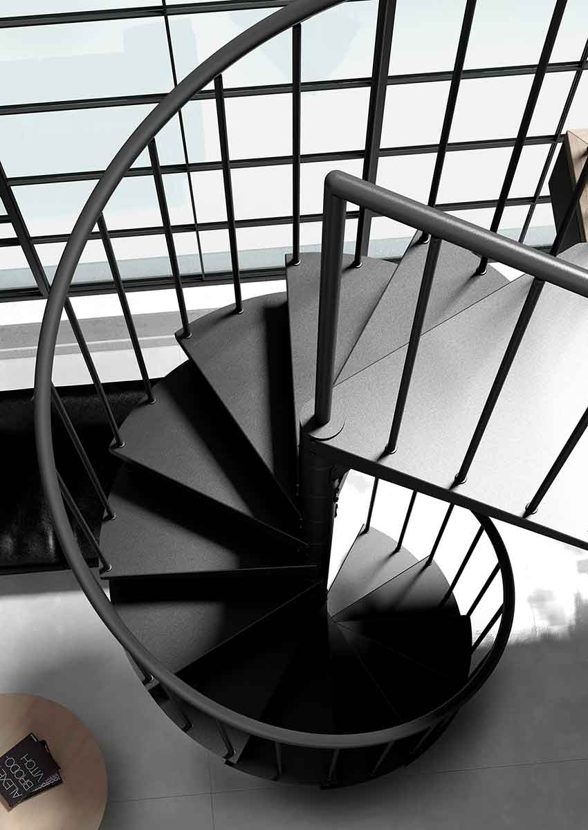 looking down on the top platform of a black steel spiral staircase
