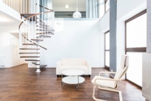 Wooden Spiral Staircase in a house leading upto the next level with dark wood floor