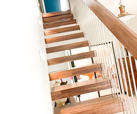 angled shot looking up a walnut open staircase