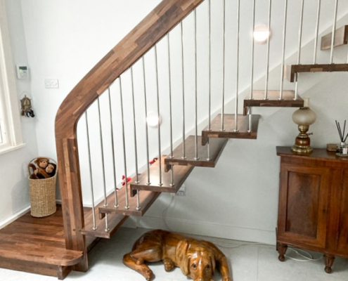 dog under a walnut staircase