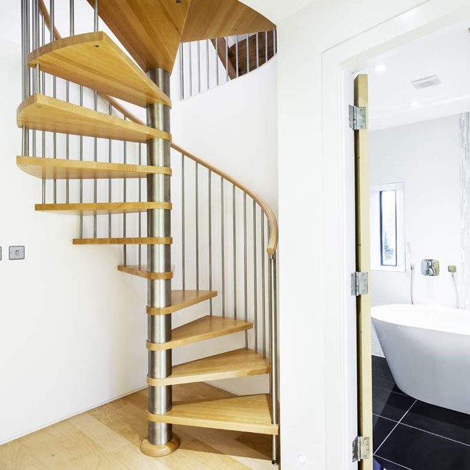 spiral stair with oak steps with white walls