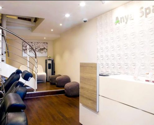 Beauty salon with chairs and a spiral stair to rear