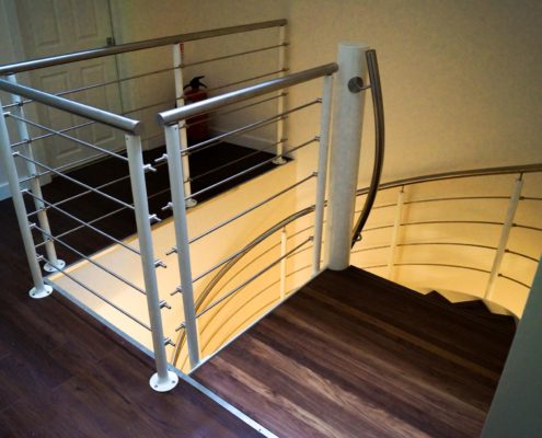 upper view of a spiral stair with walnut steps