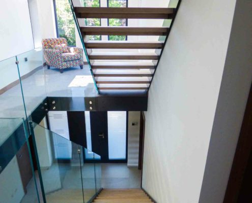 double flight modern glass staircase with open risers