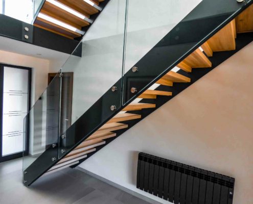 side view of a black steel stair with glass in a hallway