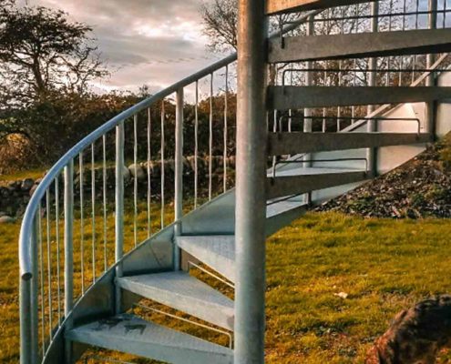 Outside spiral staircase with garden behind