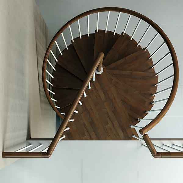 top view of triangular platform of a spiral staircase in dark wood