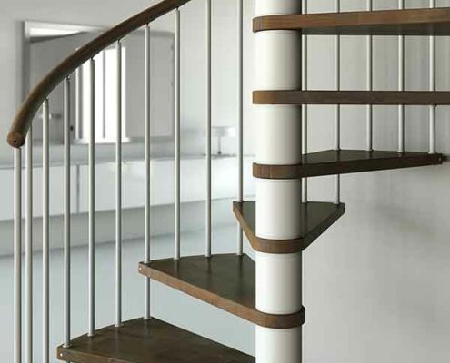 lower front view of c20 spiral stair with dark wood steps and white steel structure. Living space behind