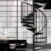 apartment with crittall window overlooking skyscrapers with black spiral stair