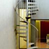 light grey steel spiral staircase with window behind