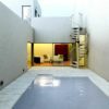 outdoor space with spiral staircase and swimming pool in foreground
