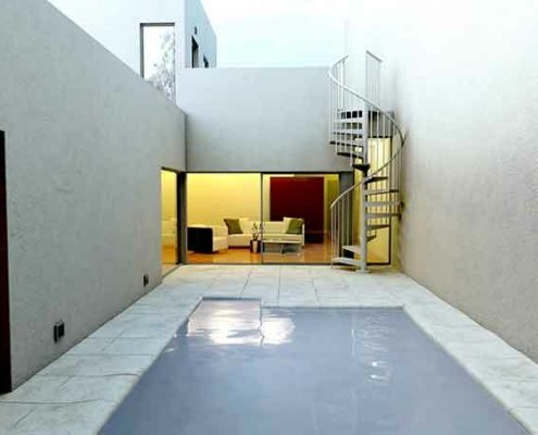 outdoor courtyard with patio and spiral stair in corner