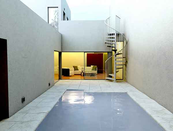 outdoor courtyard with patio and spiral stair in corner