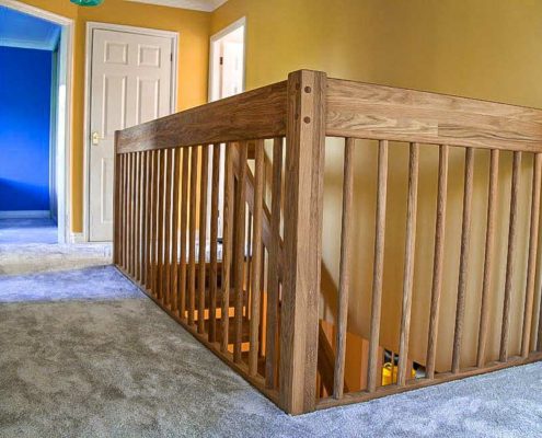 landing view of stairwell with carpet and timber spindles and handrail