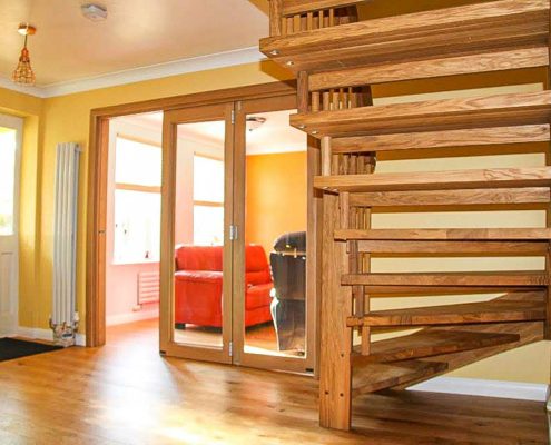 rear view of hallway with oak staircase and oak framed doorway