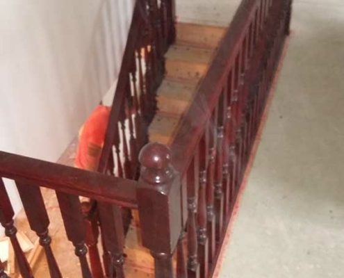 landing balustrade in dark wood spindles