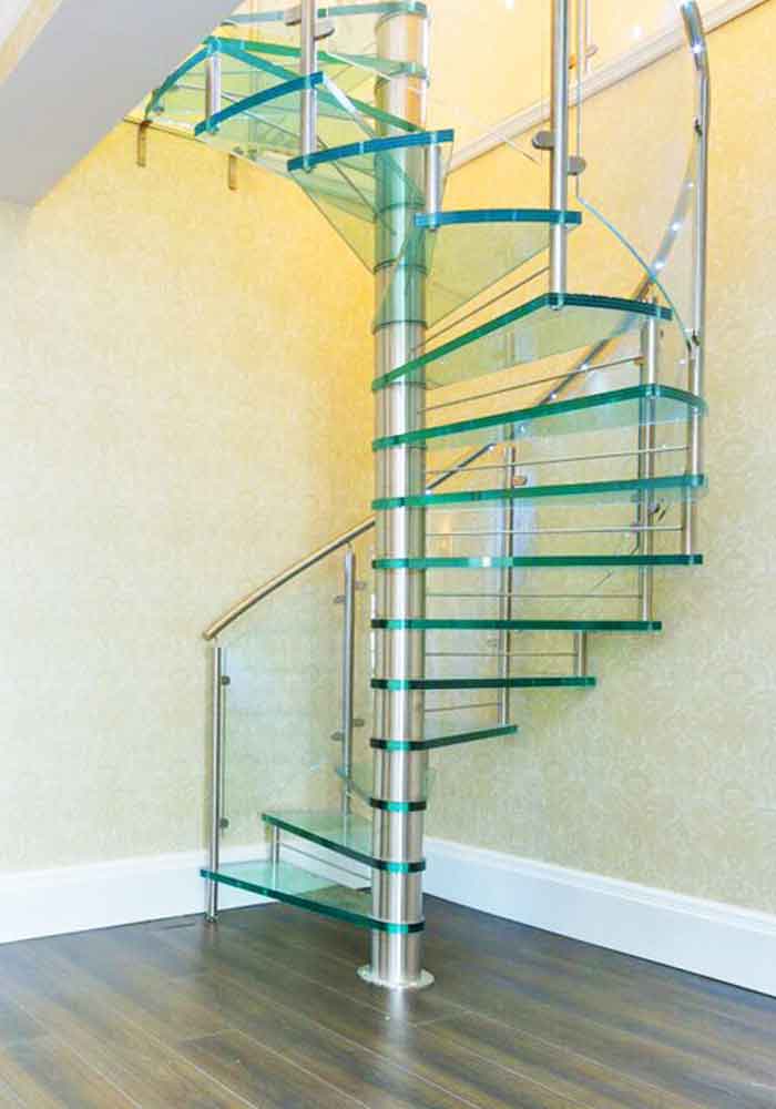 modern glass spiral stair in corner of room