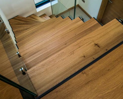 close up on oak staircase steps and glass