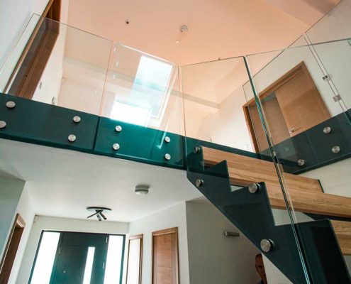 looking up at landing balustrade and stair to right