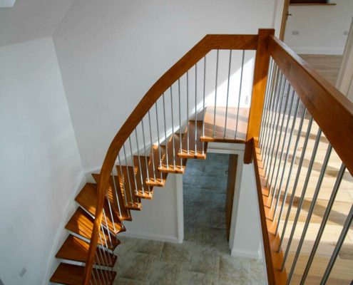view from above a floating timber stair in a hallway