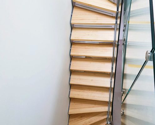 Ariel view of a half turn staircase with maple treads and glass balustrade