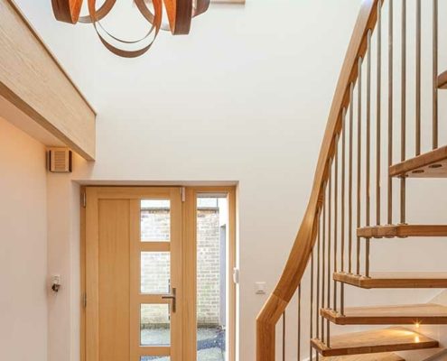 view looking at hall toward from door. Nice floating style staircase on left and timber floor.