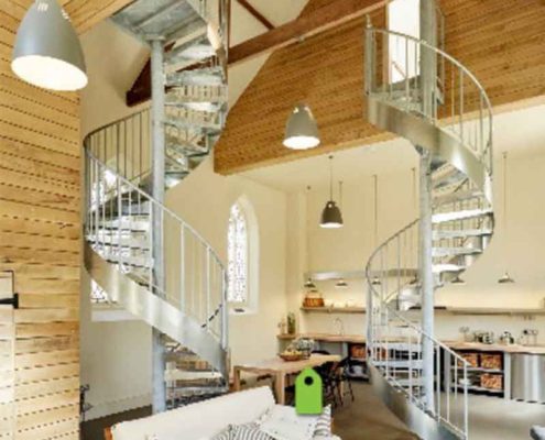 two steep spiral staircases in a domestic setting