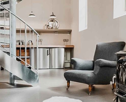 concrete floor with easy chair and steel spiral
