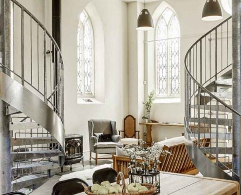 wooden table and two steel spiral stairs