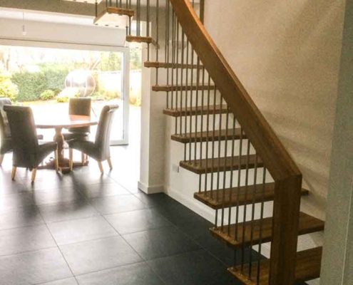 quarter turn stair in a hallway with black tiles