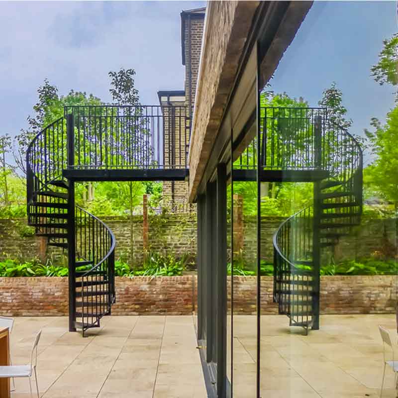 black spiral stair with reflection in window