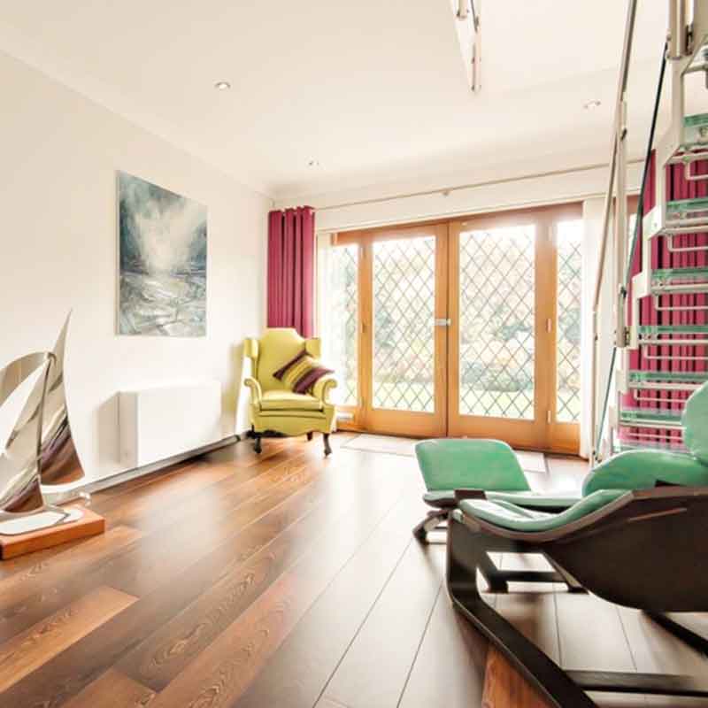 living room in a house with turquoise chaise and open stair