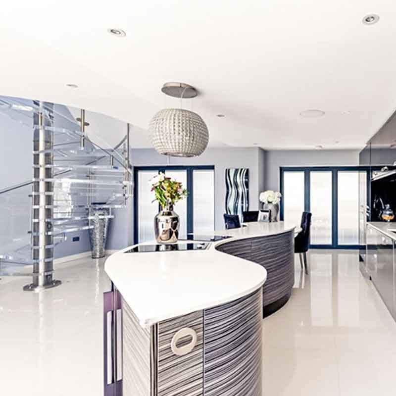 spiral staircase in acrylic behind modern kitchen