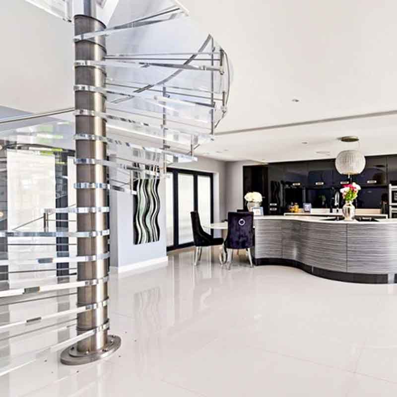 stainless spiral stair with kitchen beyond